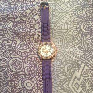 A purple and rhinestoned watch